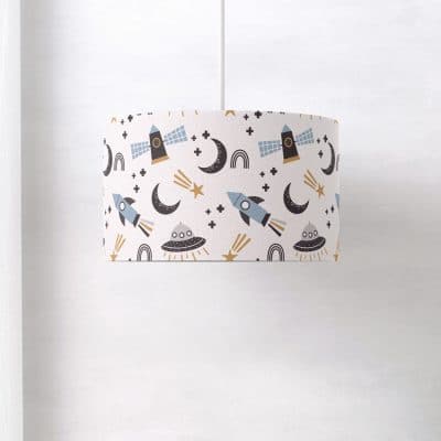 Scandi Space lampshade photographed from a side angle, showing the seamless wraparound design with soft-toned space elements on a white backdrop.