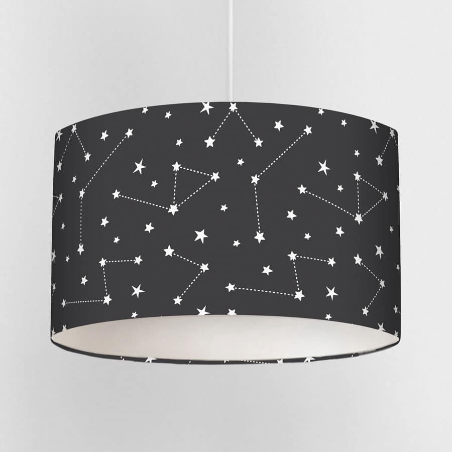 Dark constellation lampshade with seamless white star and constellation pattern on a deep charcoal background, shown close up.