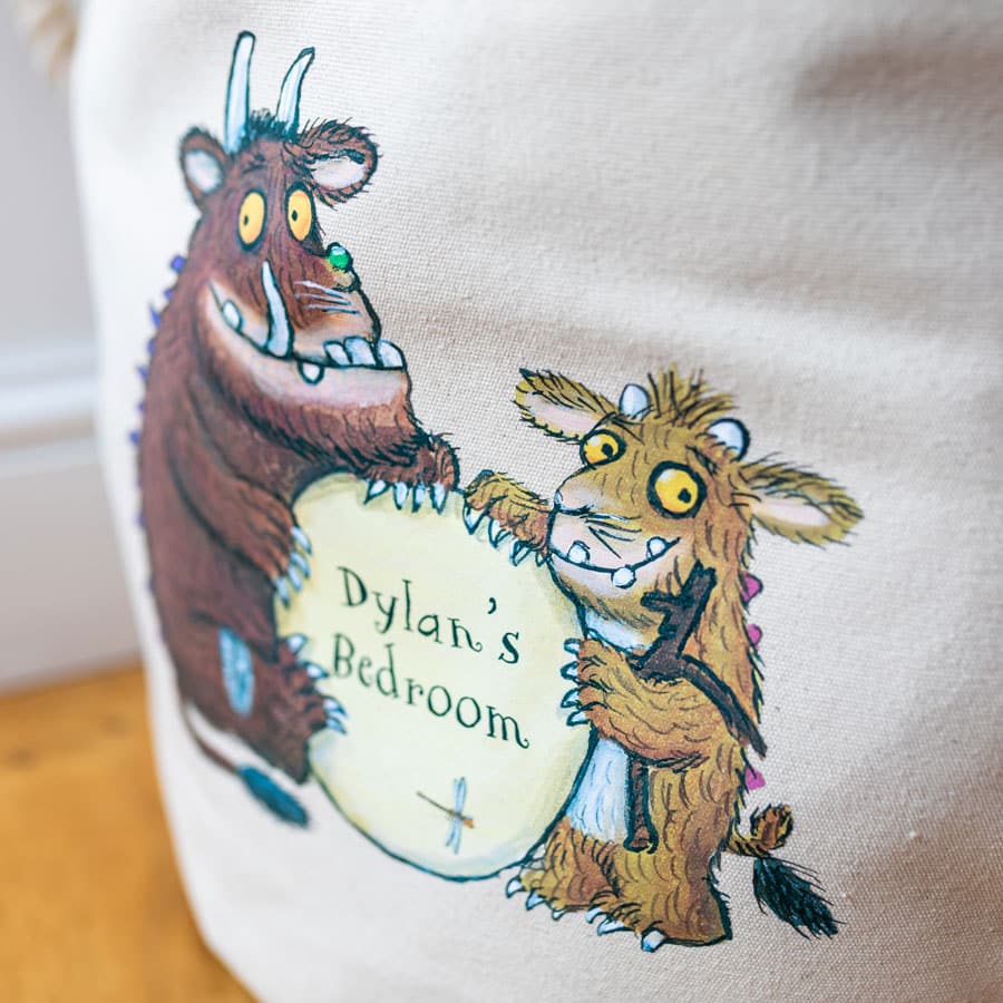 Close-up of the Gruffalo and his child illustration on a cotton canvas basket, with custom text printed on the sign – part of the official Gruffalo collection.