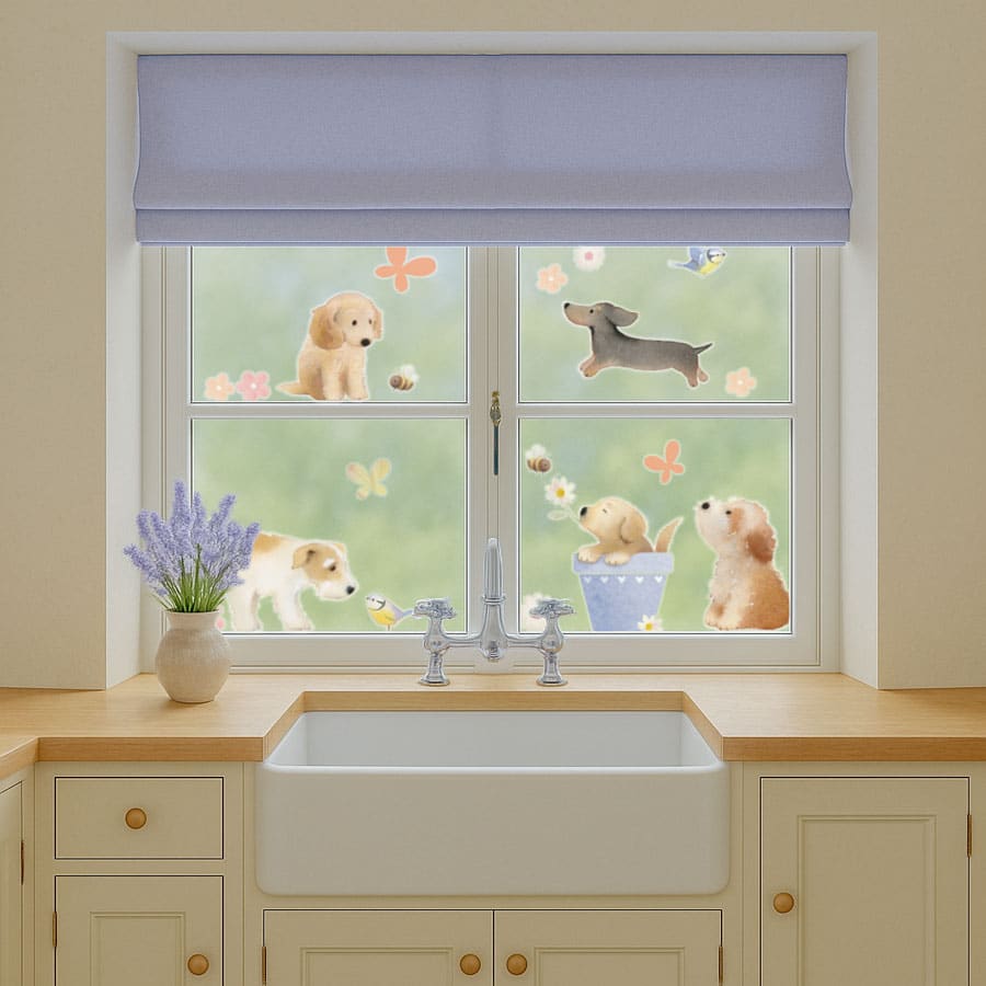 Dog window stickers displayed on a kitchen window featuring cute puppies, bees and flowers from Ginger Betty’s spring-themed set.