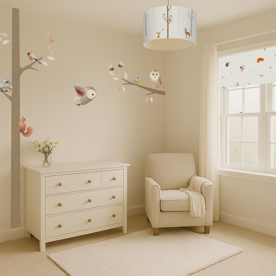 Woodland-themed nursery with Ginger Betty animal lampshade, cream armchair and coordinating wall stickers"
