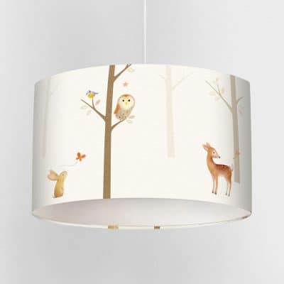 Children’s lampshade featuring owls, deer, rabbit and trees on a soft cream background