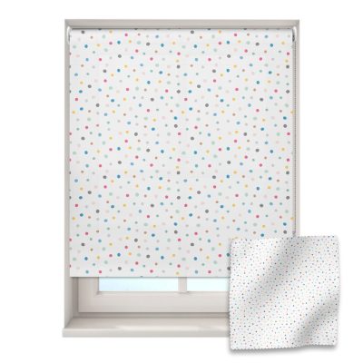 colourful spots roller blind on a window with a fabric swatch in front